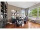 Bright home office featuring hardwood floors, built-in shelves, and a large window at 2511 Carnation Dr, Harrisburg, NC 28075
