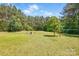 Spacious backyard with a fire pit area and plenty of shade from mature trees at 2784 Leadoff Rd, Lancaster, SC 29720