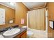 Cozy bathroom featuring a shower-tub combo and a single sink vanity with dark countertops at 2784 Leadoff Rd, Lancaster, SC 29720