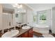 Bathroom with double sink vanity and soaking tub with large window at 2784 Leadoff Rd, Lancaster, SC 29720