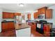 Well-lit kitchen with cherry cabinets, stainless appliances, and center island at 2784 Leadoff Rd, Lancaster, SC 29720
