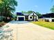 Beautiful new construction home showcasing white siding, a black roof, large driveway, and professionally landscaped yard at 2907 Lake Ave, Charlotte, NC 28208
