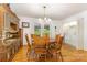 Dining room with wood flooring, table and chairs, and a view to the laundry room at 302 6Th Sw St, Conover, NC 28613