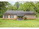 Charming brick home featuring a covered patio and well-manicured lawn at 302 6Th Sw St, Conover, NC 28613