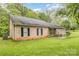 Attractive brick home with a covered patio, trimmed lawn and a black roof at 302 6Th Sw St, Conover, NC 28613