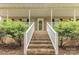 Brick steps leading up to the front door, framed by lush landscaping and white railings at 302 6Th Sw St, Conover, NC 28613