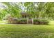 Charming brick home featuring a welcoming front porch and lush, green landscaping at 302 6Th Sw St, Conover, NC 28613