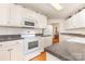Well-lit white kitchen featuring modern appliances and ample counter space for cooking at 302 6Th Sw St, Conover, NC 28613