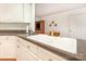 Spacious kitchen with white cabinets, granite counters, and a stainless steel sink at 302 6Th Sw St, Conover, NC 28613