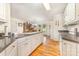 Bright kitchen with white cabinets, granite countertops, and hardwood floors at 302 6Th Sw St, Conover, NC 28613