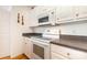 Eat-in kitchen with white appliances and white cabinets, offering functional cooking space at 302 6Th Sw St, Conover, NC 28613