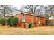 Brick house with an access stairs, some trash cans, and utilities visible on the back at 3232 Marlborough Rd, Charlotte, NC 28208