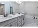 Elegant bathroom with double sinks, marble countertops, and a luxurious soaking tub at 3252 Cheyney Park Dr, Charlotte, NC 28269