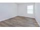 This bedroom is bright with natural light and features sleek wood flooring throughout at 3252 Cheyney Park Dr, Charlotte, NC 28269