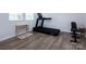 Home gym featuring exercise equipment and wood-look floors; an inviting space to maintain an active lifestyle at 3252 Cheyney Park Dr, Charlotte, NC 28269
