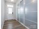 Hallway featuring wood-look flooring, a front door with windows, and a closet with sliding mirrored doors at 3252 Cheyney Park Dr, Charlotte, NC 28269