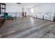 Upstairs loft area boasts wood floors, seating, and natural light from windows at 3252 Cheyney Park Dr, Charlotte, NC 28269