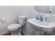 A clean powder room with a pedestal sink, a modern faucet, and a white toilet for a minimalist aesthetic at 3252 Cheyney Park Dr, Charlotte, NC 28269