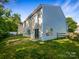 Backyard featuring a grassy area, a wooden fence, and the back of the home at 3510 Heathcott Cir, Charlotte, NC 28262