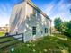 View of the house from the backyard, featuring green grass and a clear blue sky at 3510 Heathcott Cir, Charlotte, NC 28262