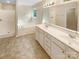 Bathroom featuring double sinks, a soaking tub, and a separate shower at 3510 Heathcott Cir, Charlotte, NC 28262