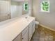 Bathroom showcasing a vanity with ample counter space, cabinets, and natural light from the window at 3510 Heathcott Cir, Charlotte, NC 28262