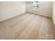 Neutral empty bedroom featuring neutral carpet, and window with backyard view at 3510 Heathcott Cir, Charlotte, NC 28262