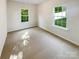 Bright bedroom with plush carpet and a large window overlooking a green outdoor view at 3510 Heathcott Cir, Charlotte, NC 28262