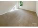 Bright bedroom featuring neutral carpet and a window offering a pleasant view at 3510 Heathcott Cir, Charlotte, NC 28262