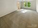 Neutral bedroom showcasing plush carpet, generous natural light, and easy access to bath at 3510 Heathcott Cir, Charlotte, NC 28262