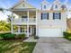 Charming two-story home features a covered porch, second-story balcony, and attached garage at 3510 Heathcott Cir, Charlotte, NC 28262