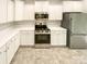 Modern kitchen featuring white cabinets, stainless steel appliances, and tile floors at 3510 Heathcott Cir, Charlotte, NC 28262