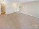 Spacious living room with neutral carpet and easy access to other areas of the home at 3510 Heathcott Cir, Charlotte, NC 28262
