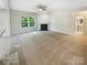Spacious living room featuring a fireplace, neutral carpet and large window at 3510 Heathcott Cir, Charlotte, NC 28262