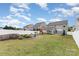 Expansive backyard with a fire pit, play set, and ample green space for outdoor activities at 3618 Catherine Creek Pl, Davidson, NC 28036