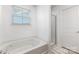 Bright bathroom featuring a large tub and glass shower at 3618 Catherine Creek Pl, Davidson, NC 28036