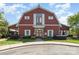 Exterior shot of the clubhouse, featuring a barn-like design with red siding and well-manicured landscaping at 3618 Catherine Creek Pl, Davidson, NC 28036
