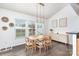 Bright dining area with a modern table, stylish lighting, and views of the backyard at 3618 Catherine Creek Pl, Davidson, NC 28036