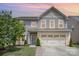 Charming two-story home with a well-maintained lawn, landscaped garden, and a spacious two-car garage at 3618 Catherine Creek Pl, Davidson, NC 28036