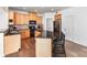Kitchen with black appliances, a breakfast bar, and wood floors at 3618 Catherine Creek Pl, Davidson, NC 28036