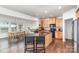 Modern kitchen with a large island, stainless steel appliances, and an adjacent dining area at 3618 Catherine Creek Pl, Davidson, NC 28036