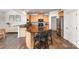 Open kitchen boasts stainless steel appliances, a breakfast bar, and wood floors at 3618 Catherine Creek Pl, Davidson, NC 28036