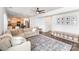 Open-concept living room with a large sectional sofa flowing into the kitchen and dining area at 3618 Catherine Creek Pl, Davidson, NC 28036