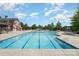 Expansive community pool area with a splash pad, pergola-covered seating, and clear blue water at 3618 Catherine Creek Pl, Davidson, NC 28036