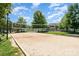 A well-maintained sand volleyball court surrounded by lush greenery, perfect for outdoor recreation at 3618 Catherine Creek Pl, Davidson, NC 28036