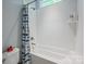 Clean bathroom featuring a shower-tub combo and white subway tile at 3992 Blue Dory Ln, Denver, NC 28037