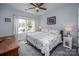 Serene bedroom with a starfish themed quilt, ceiling fan, and ample natural light for a peaceful retreat at 3992 Blue Dory Ln, Denver, NC 28037