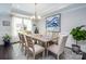 Dining room with a large window, chandelier, and a painting on the wall at 3992 Blue Dory Ln, Denver, NC 28037