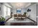 Formal dining room featuring a large window, elegant chandelier, and a stylish table set for a meal at 3992 Blue Dory Ln, Denver, NC 28037