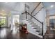 Elegant foyer with hardwood floors, a grand staircase, and tasteful decor leading to the dining area at 3992 Blue Dory Ln, Denver, NC 28037